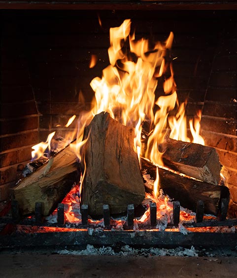 Burning fireplace, real wood logs, cozy warm home