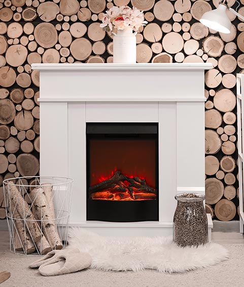 Interior of stylish living room with mantelpiece, firewood and glowing lamps